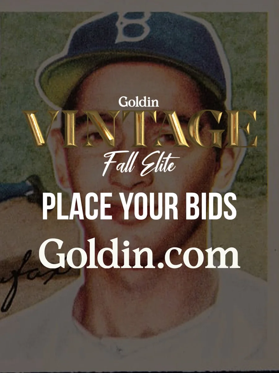 A vintage baseball card image is overlaid with text promoting a Goldin auction event. The text reads: “Goldin Vintage Fall Elite. Place your bids. Goldin.com.” A baseball player is depicted in the background.