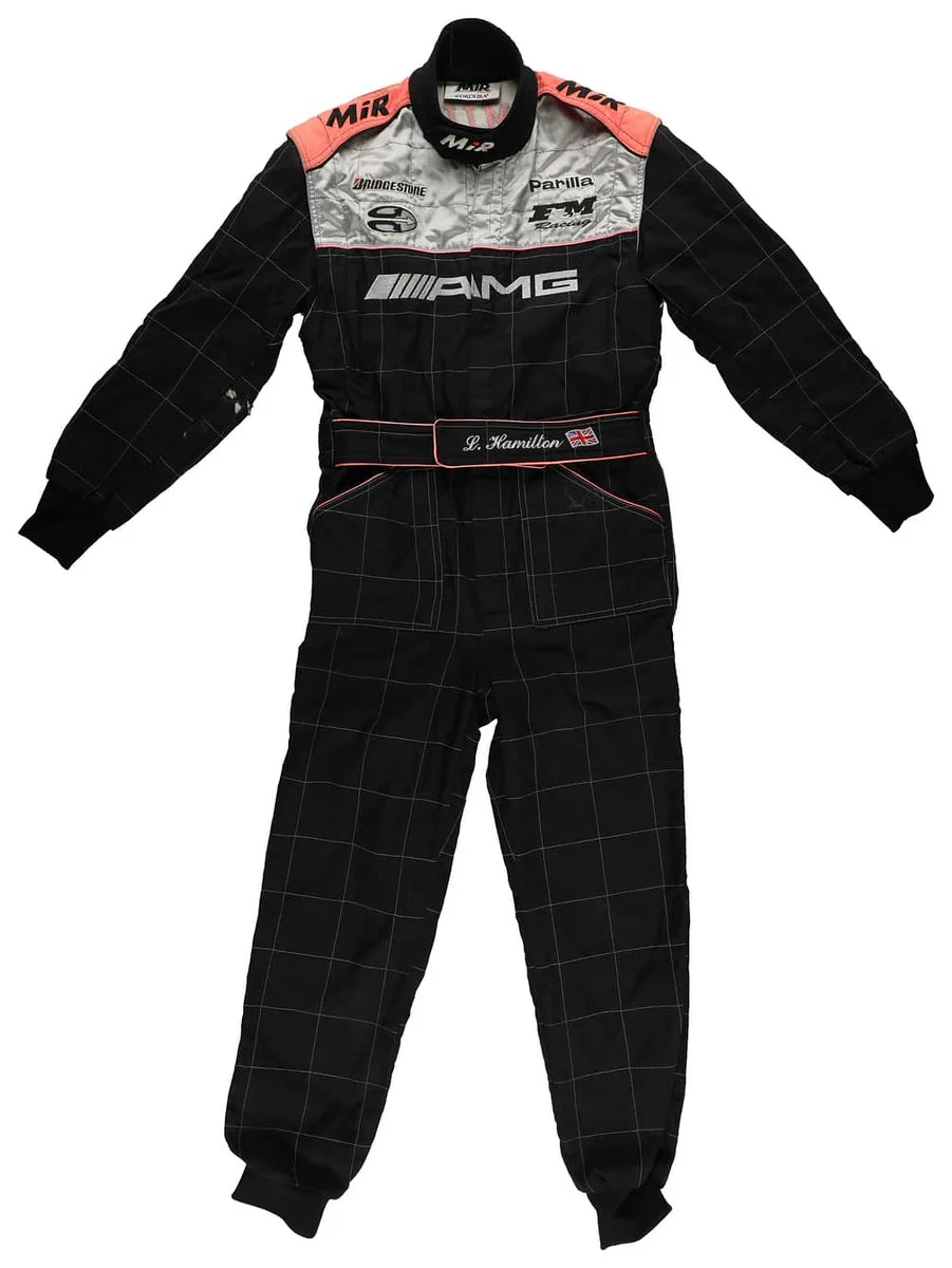 A black racing suit with white and red accents, featuring the AMG logo and various sponsor logos. The belt area displays the name "L. Hamilton" with a small flag motif.
