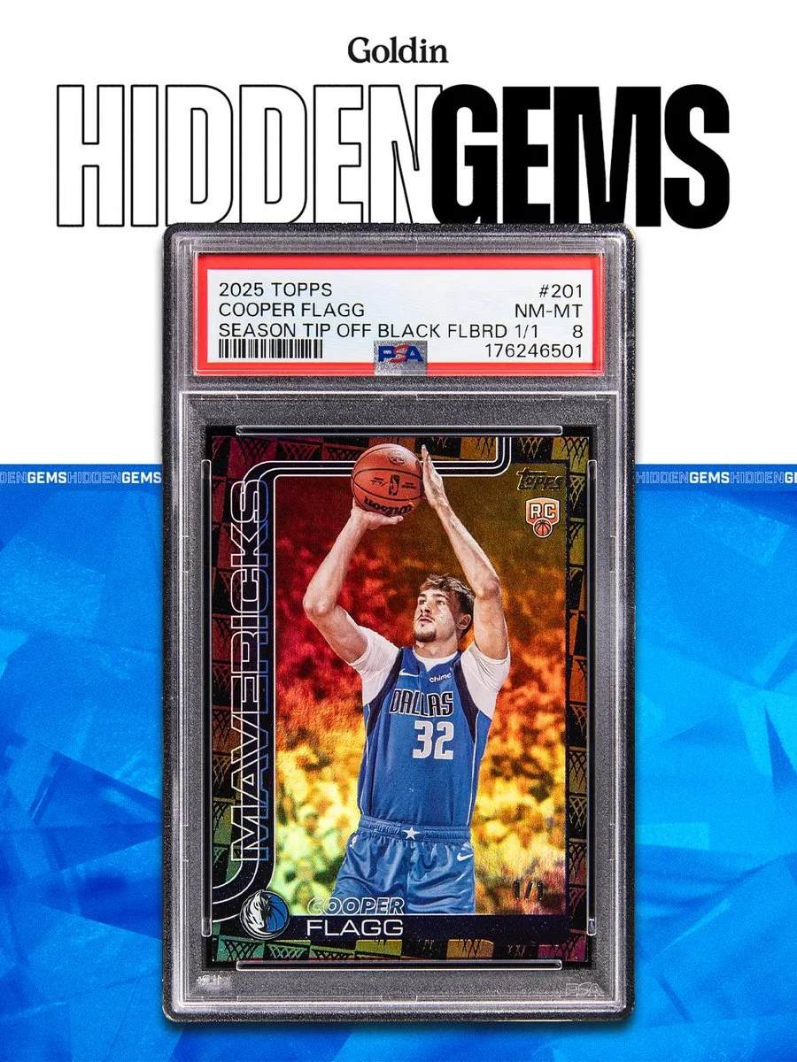 This image features a trading card encased in a protective sleeve. The card shows an individual in a basketball uniform with "Mavericks" written on it. The background is a mix of blue tones with the words "Goldin Hidden Gems" at the top.