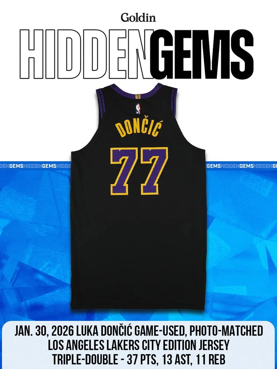 A Los Angeles Lakers City Edition jersey is displayed, featuring the name "Dončić" and the number 77. The image promotes a Goldin auction event titled "Hidden Gems." At the bottom, text includes details about a game on January 30, 2026, where Luka Dončić achieved a triple-double.