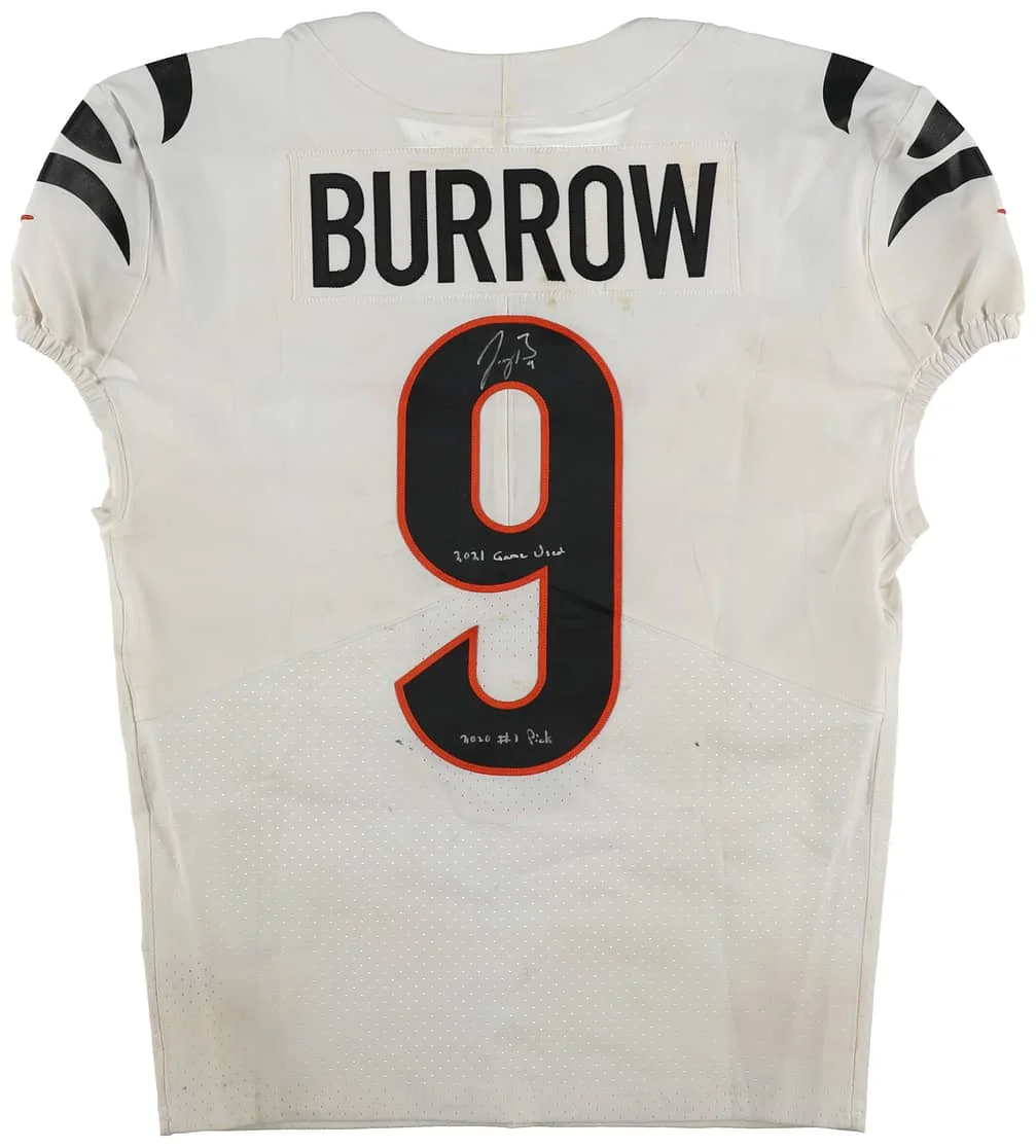 White football jersey with black and orange accents featuring the name "Burrow" and the number "9" on the back. The jersey is signed.
