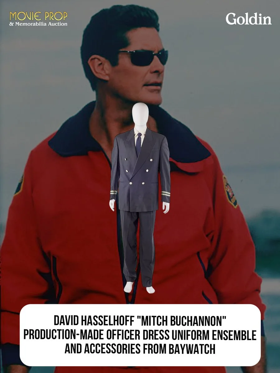 This image features a mannequin displaying an officer dress uniform ensemble with accessories from "Baywatch." The background shows a person wearing a red jacket with a lifeguard emblem. Text includes "Movie Prop & Memorabilia Auction" and "Goldin," along with a description of the uniform belonging to the character "Mitch Buchannon.