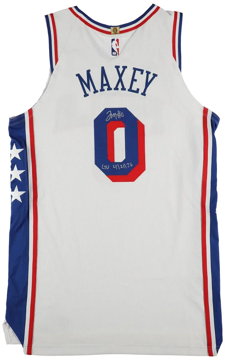 Philadelphia 76ers basketball jersey with the name "Maxey" and the number 0. The jersey is signed with an inscription. It features red, white, and blue colors with stars on the side.
