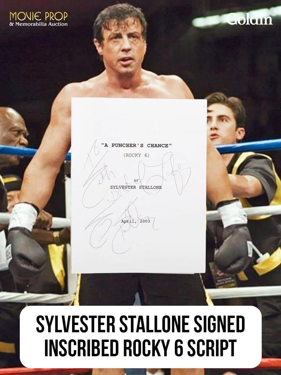 Image of a person in a boxing ring holding a signed script with "A Puncher's Chance" (Rocky 6) written on it. The script is signed by Sylvester Stallone, dated April 2003. The background shows a person in boxing attire. Text at the top reads, "Movie Prop & Memorabilia Auction," and at the bottom, "Sylvester Stallone Signed Inscribed Rocky 6 Script.