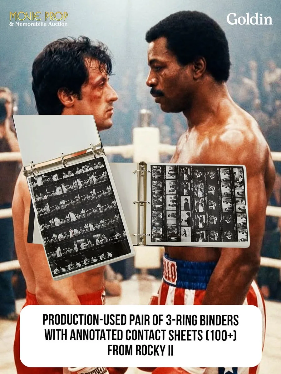 The image shows two individuals facing each other in a boxing ring, both appearing focused and serious. In the foreground, there are two open 3-ring binders displaying annotated contact sheets from "Rocky II." The top corners are labeled "Movie Prop & Memorabilia Auction" and "Goldin.
