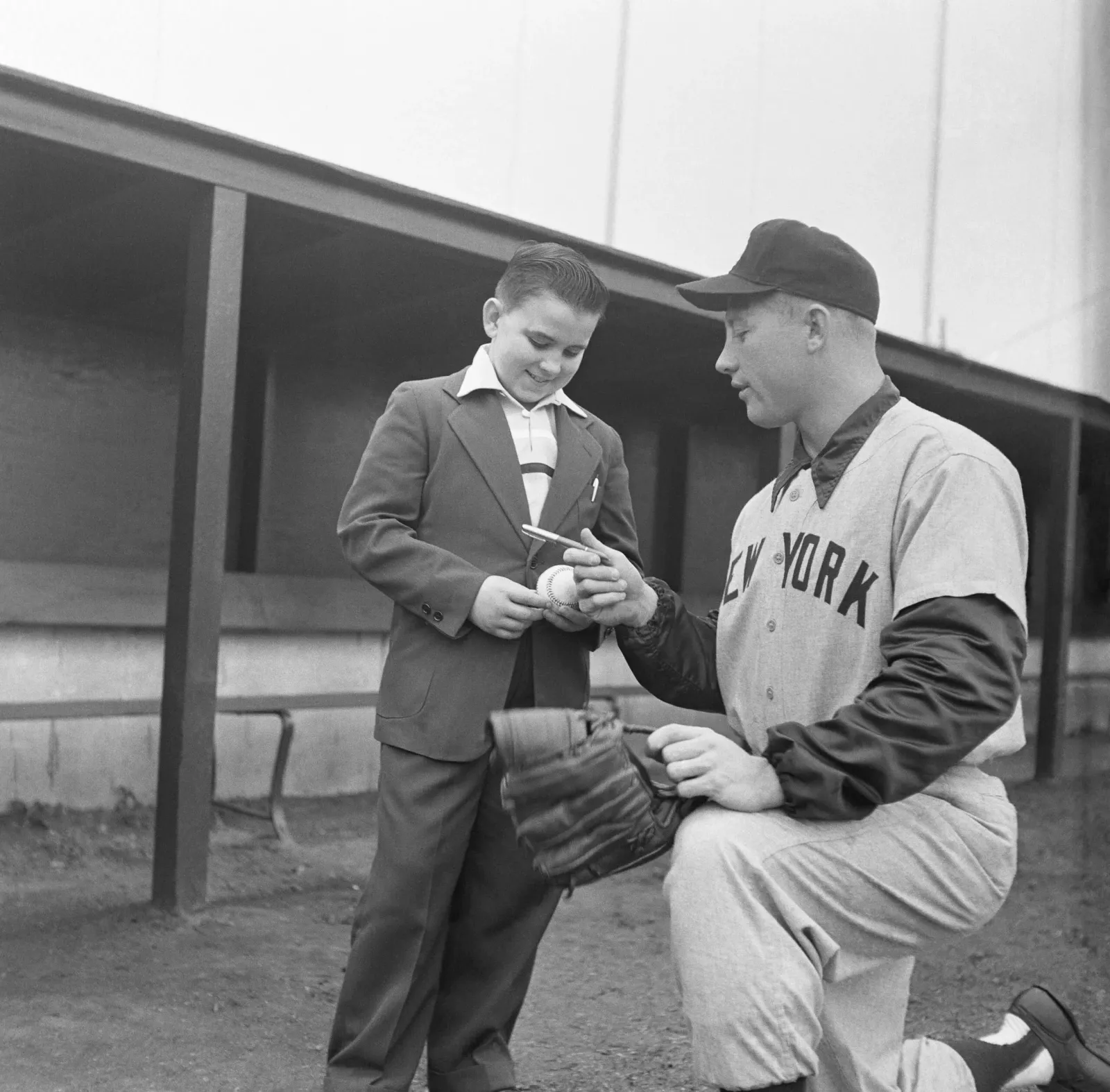 Mickey Mantle signs an autograph for a young fan, circa 1950-51.