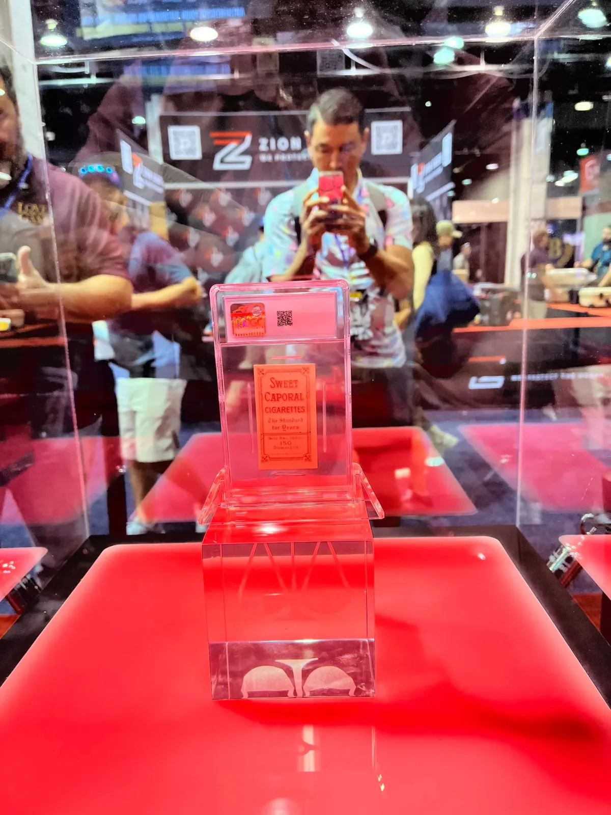 A collector checks out the T206 Restored Honus Wagner card at the CGC booth at The National.