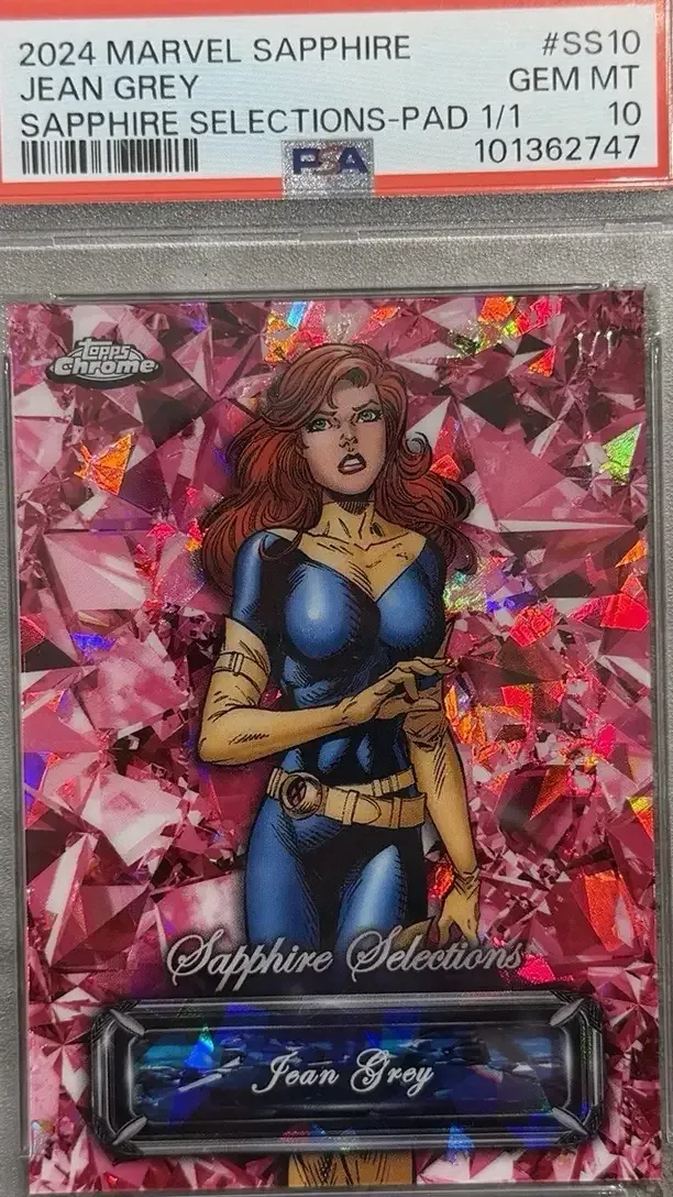 Jean Grey in X-men uniform over orange pink refractor background on 2024 topps chrome marvel sapphire selections card.