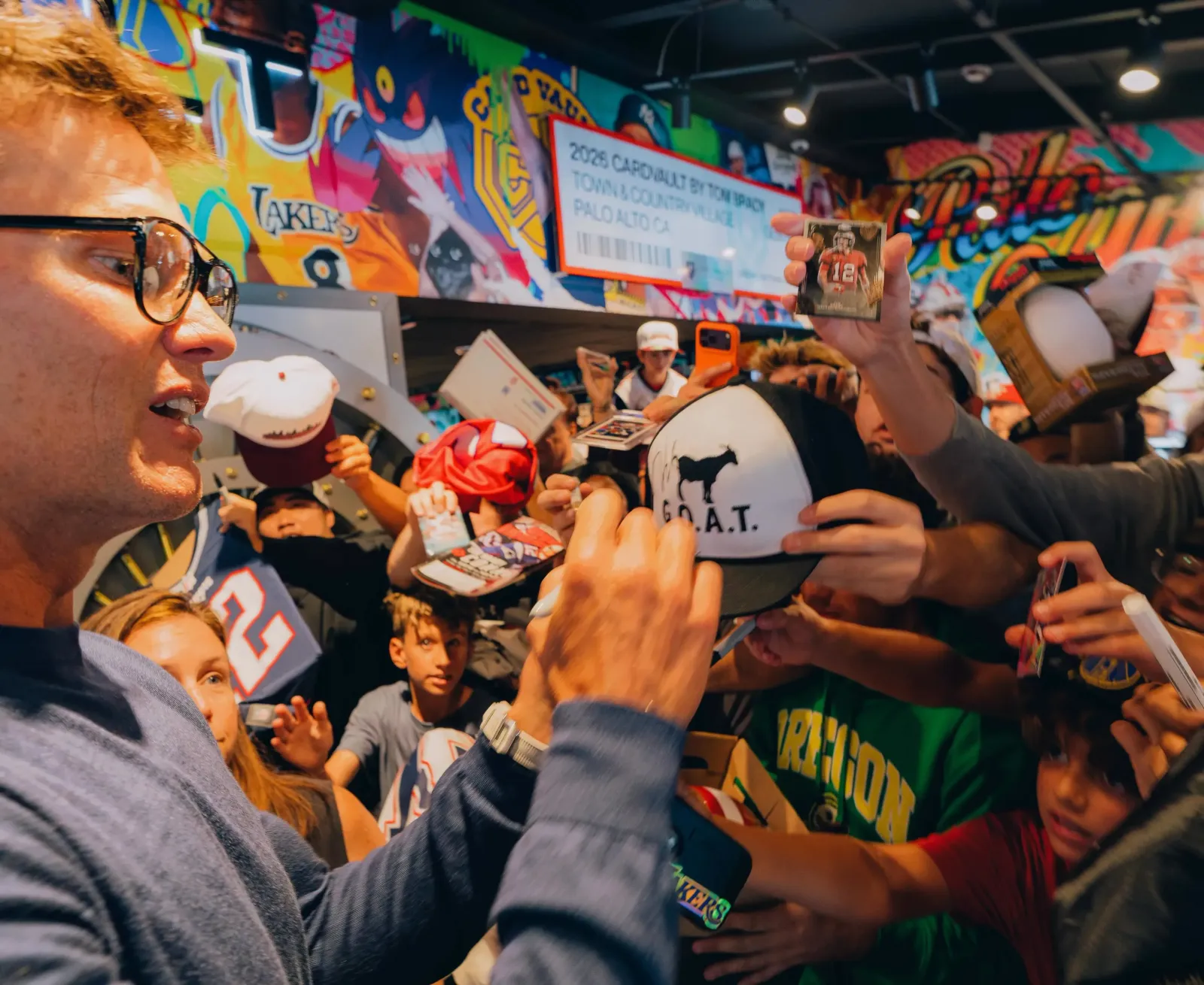 Tom Brady signed memorabilia and posed for photos with fans who attended the opening of the new CardVault by Tom Brady store.