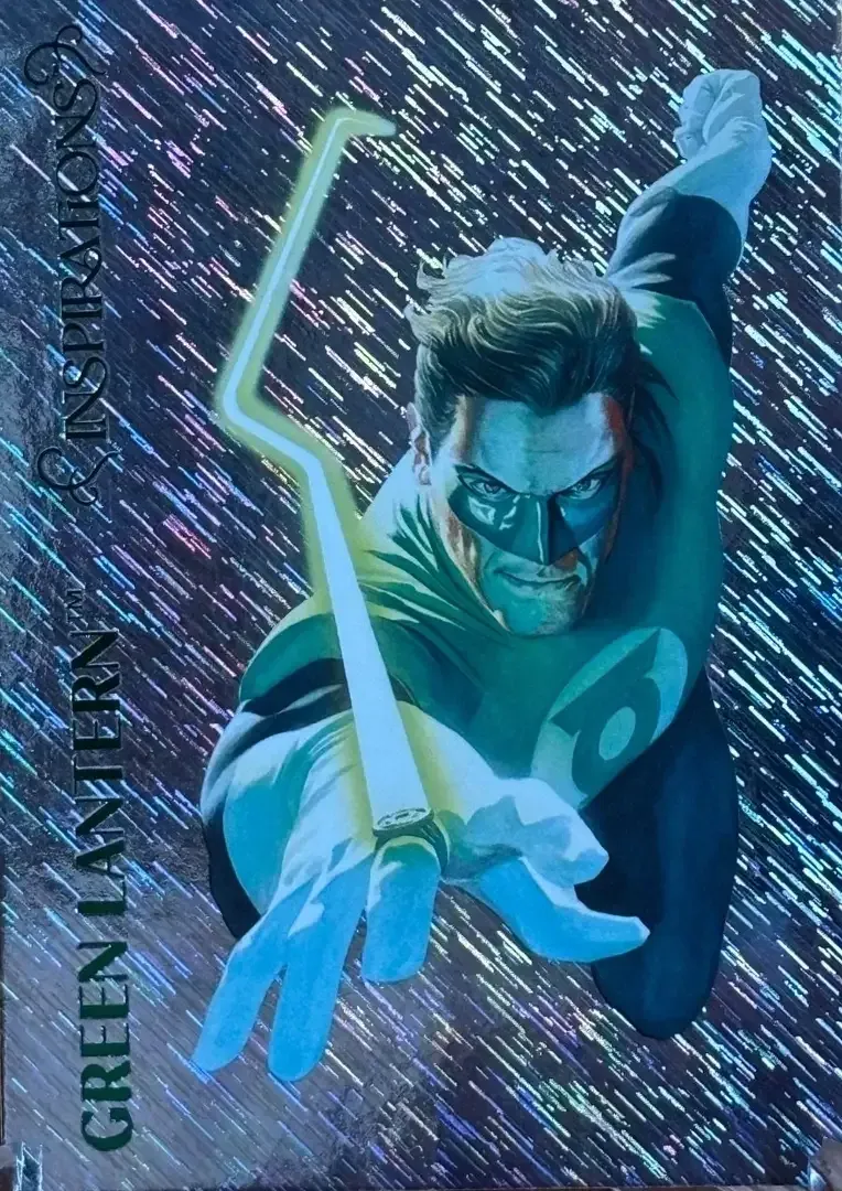 A trading card with glimmering background and Green Lantern flying with right hand extended and ring with with beam of light