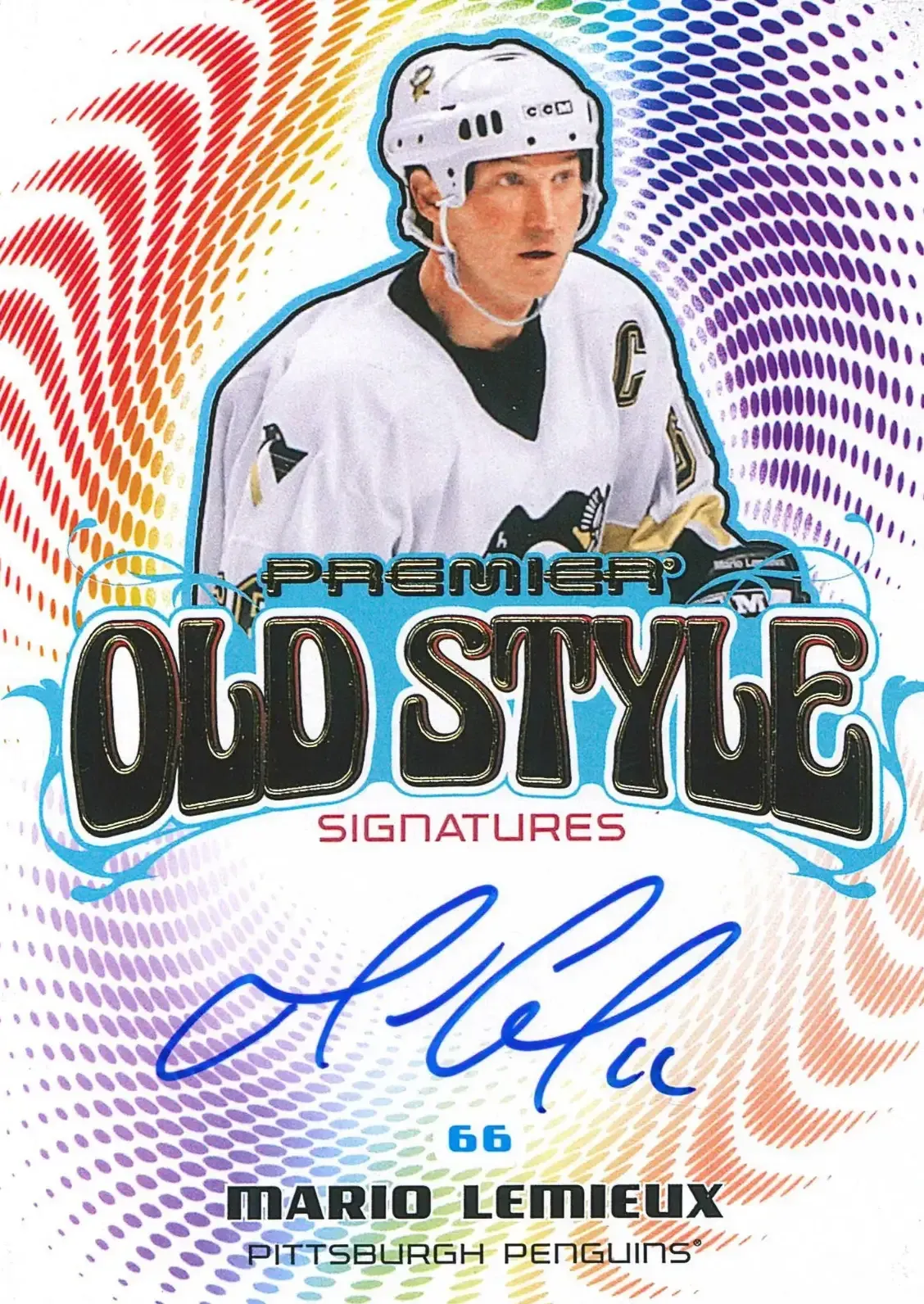 Rainbow colors encircles the player who is in the center of the card and blue autograph below his picture.