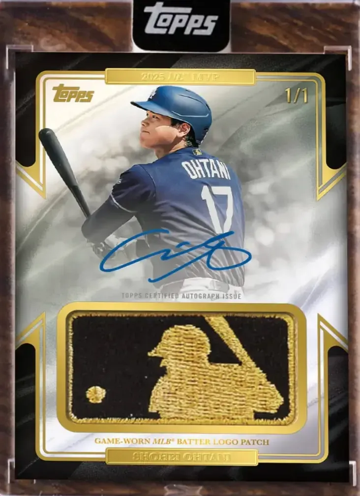 Image of player in background of card with gold MLB patch on bottom and blue auto between player and patch.