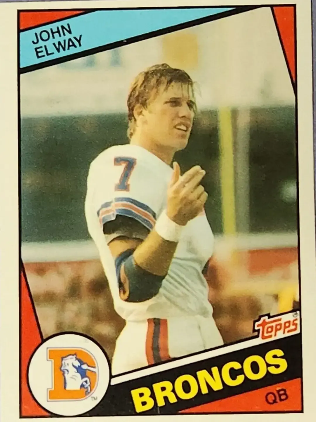 Denver Broncos Quarterback John Elway on rookie card with wet hair and gesturing with his right hand.