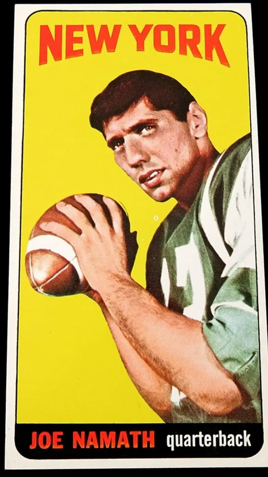 Picture of card featuring player in green New York Jets Jersey on yellow background. Red lettered New York.